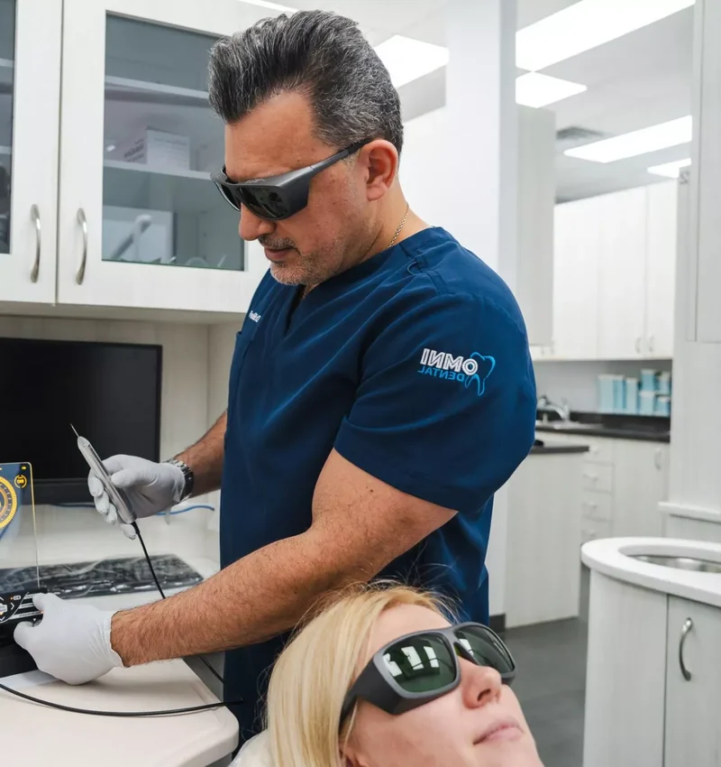 Dr. Bilus Poles performing laser gum treatment at Omni Dental in Arlington Heights