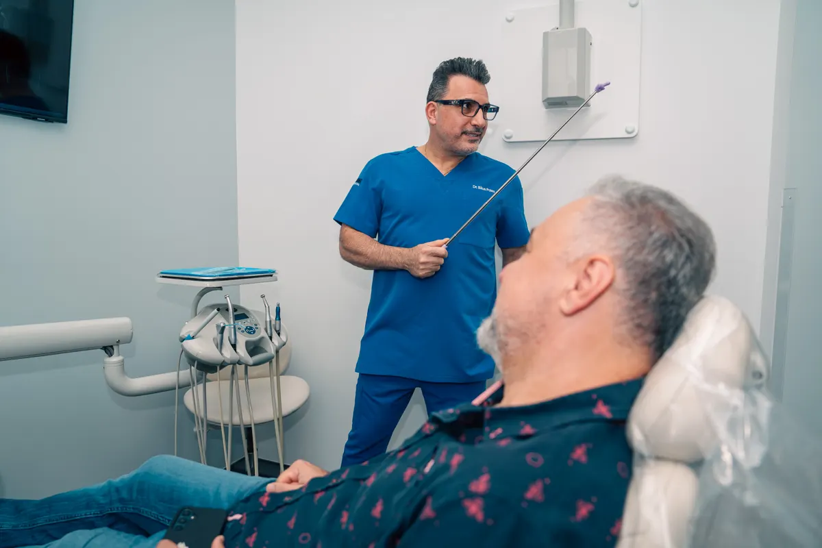 Dr. Bilus Poles showing a scan to a patient at Omni Dental in Arlington Heights